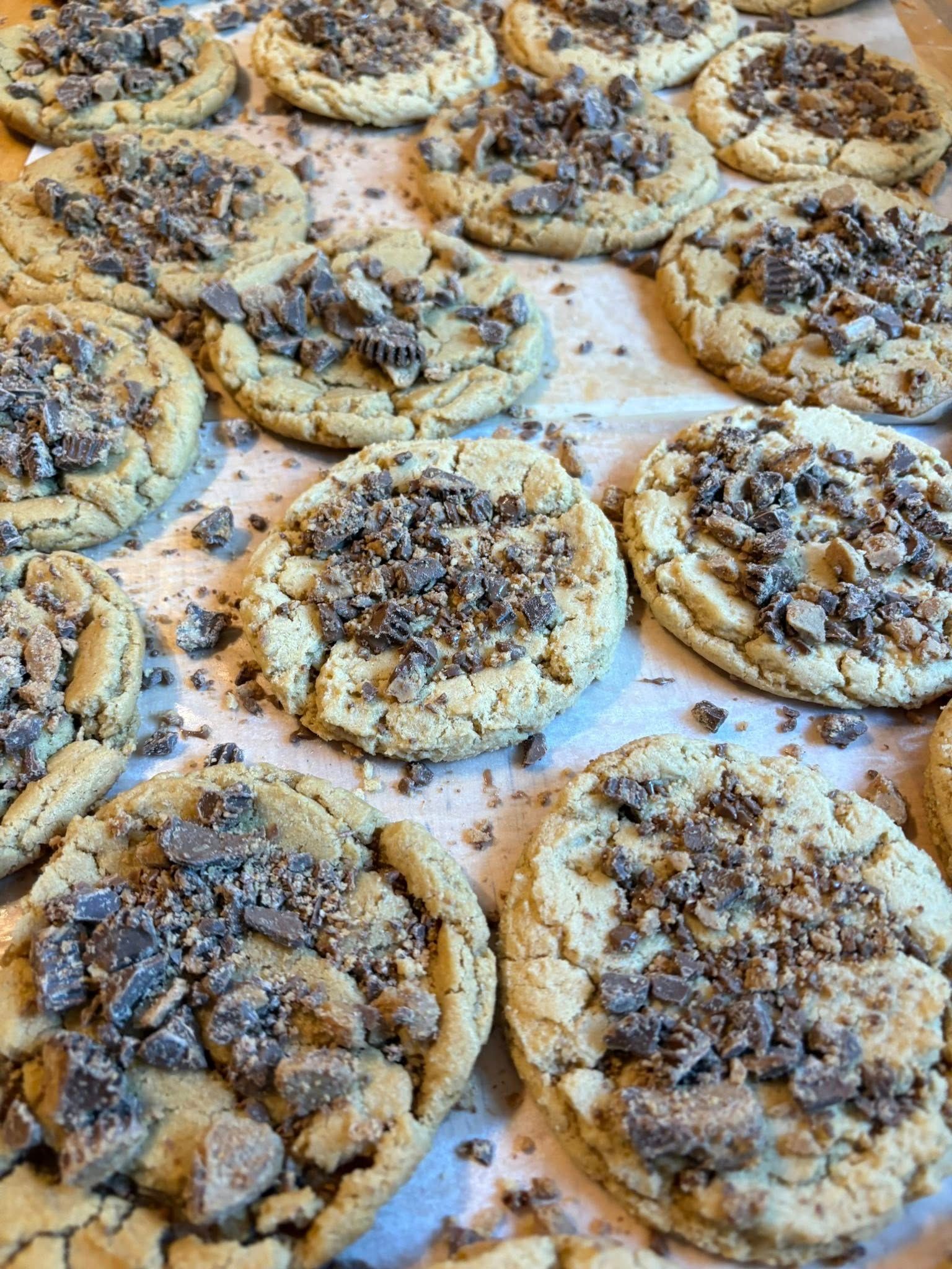 Cookies with crushed candy topping on a baking sheet. Base Camp Bakery Gunnison, Colorado https://share.google/AgqUzUKNzsb0ThlP5, https://www.facebook.com/BaseCampBakery1, https://www.instagram.com/basecampbakery_81230