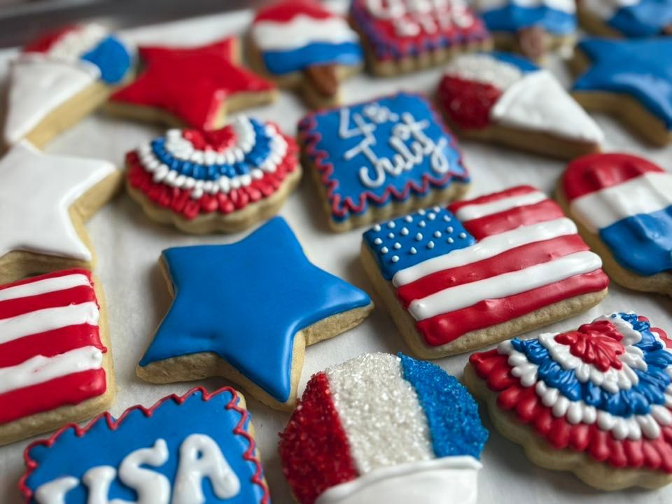 Assortment of patriotic cookies decorated with red, white, and blue icing for the 4th of July. Base Camp Bakery Gunnison, Colorado https://share.google/AgqUzUKNzsb0ThlP5, https://www.facebook.com/BaseCampBakery1, https://www.instagram.com/basecampbakery_81230