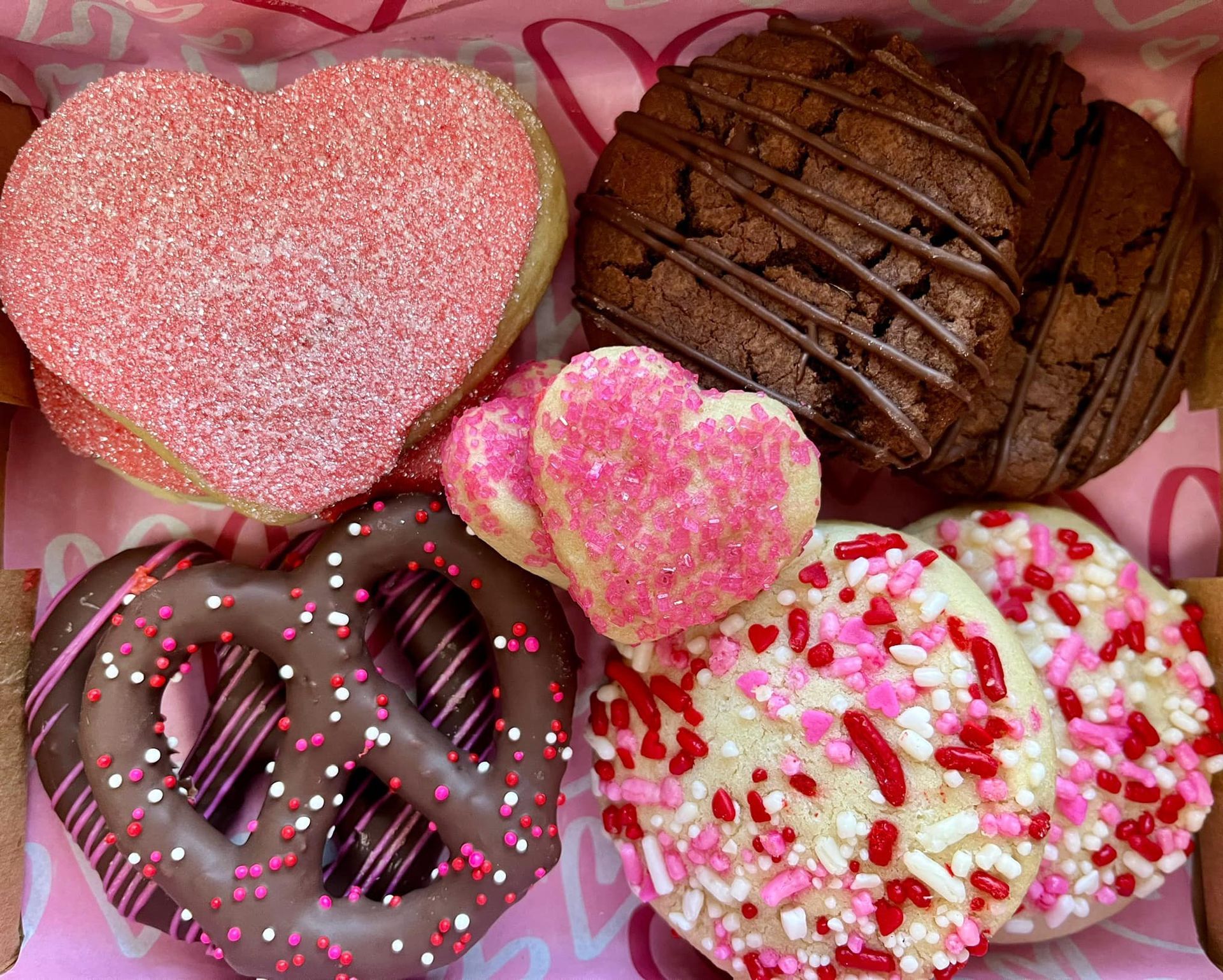 Valentine's Day cookies in a box: heart-shaped, chocolate-covered pretzel, and sprinkles. Base Camp Bakery Gunnison, Colorado https://share.google/AgqUzUKNzsb0ThlP5, https://www.facebook.com/BaseCampBakery1, https://www.instagram.com/basecampbakery_81230