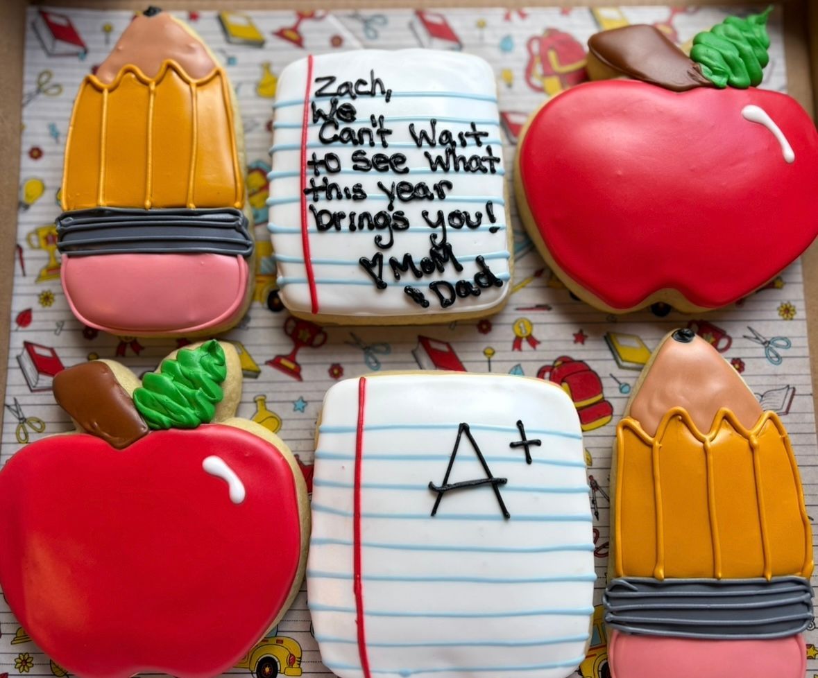 Back-to-school cookies: pencils, apples, and notepaper with messages, decorated with icing. Base Camp Bakery Gunnison, Colorado https://share.google/AgqUzUKNzsb0ThlP5, https://www.facebook.com/BaseCampBakery1, https://www.instagram.com/basecampbakery_81230