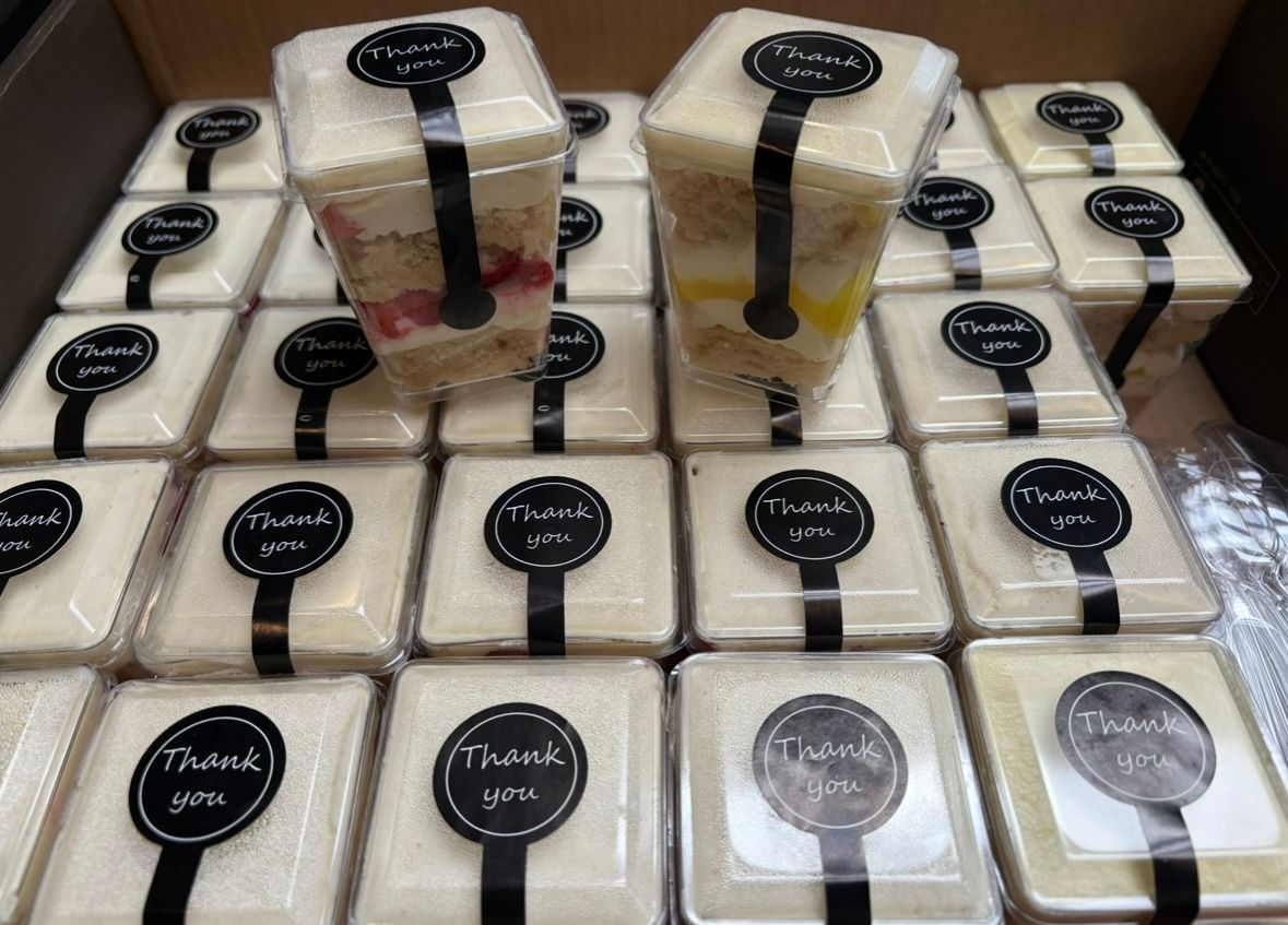Square cake slices in clear plastic containers, black. Base Camp Bakery Gunnison, Colorado https://share.google/AgqUzUKNzsb0ThlP5, https://www.facebook.com/BaseCampBakery1, https://www.instagram.com/basecampbakery_81230