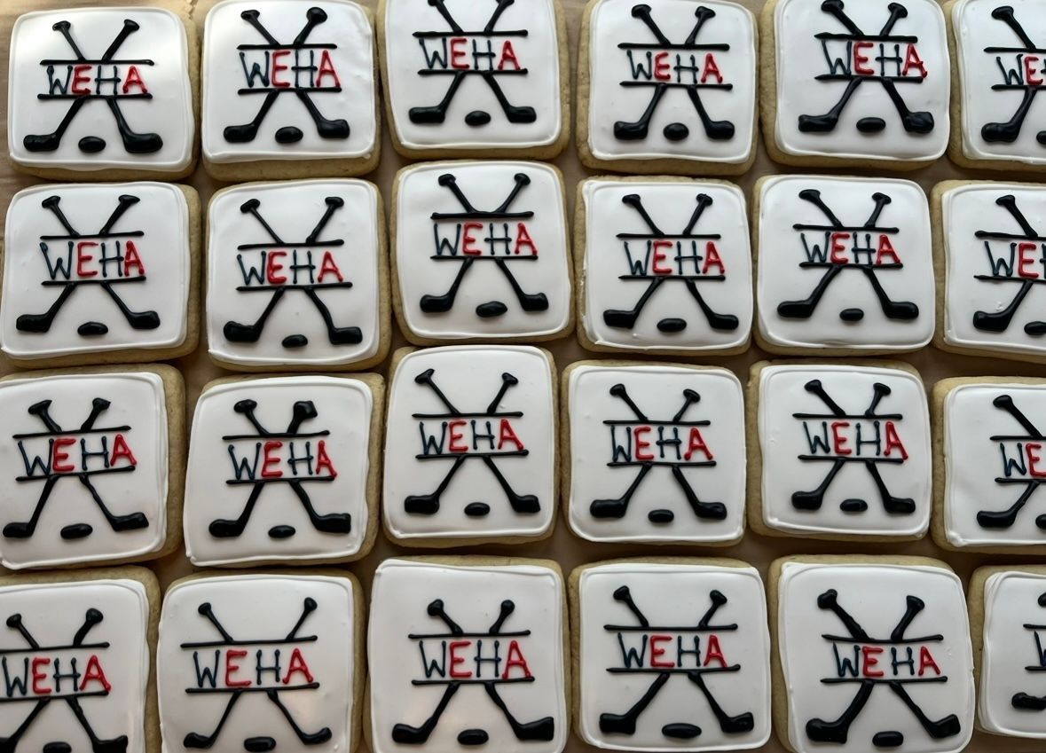 Square cookies with white icing, black hockey sticks and red. Base Camp Bakery Gunnison, Colorado https://share.google/AgqUzUKNzsb0ThlP5, https://www.facebook.com/BaseCampBakery1, https://www.instagram.com/basecampbakery_81230