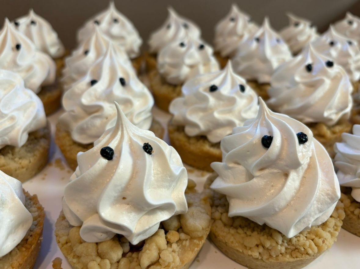 Mini tarts with white meringue swirls and black dot. Base Camp Bakery Gunnison, Colorado https://share.google/AgqUzUKNzsb0ThlP5, https://www.facebook.com/BaseCampBakery1, https://www.instagram.com/basecampbakery_81230