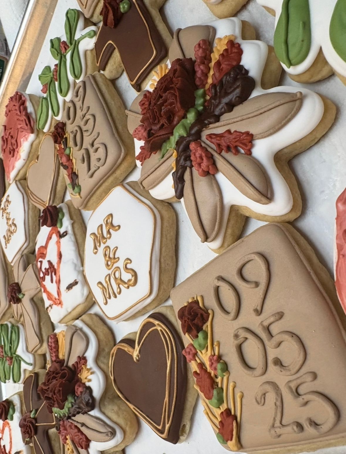 Decorated cookies with wedding theme. Base Camp Bakery Gunnison, Colorado https://share.google/AgqUzUKNzsb0ThlP5, https://www.facebook.com/BaseCampBakery1, https://www.instagram.com/basecampbakery_81230