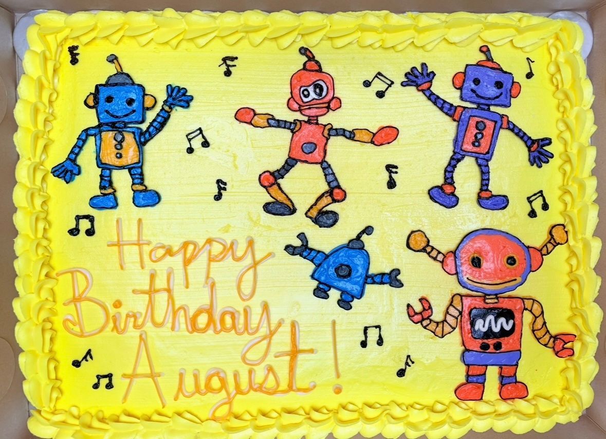 Yellow cake decorated with colorful robot characters. Base Camp Bakery Gunnison, Colorado https://share.google/AgqUzUKNzsb0ThlP5, https://www.facebook.com/BaseCampBakery1, https://www.instagram.com/basecampbakery_81230