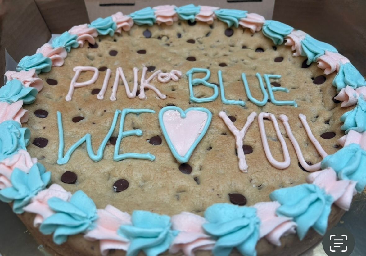 Pink and blue decorated chocolate chip cookie cake for a baby shower. Base Camp Bakery Gunnison, Colorado https://share.google/AgqUzUKNzsb0ThlP5, https://www.facebook.com/BaseCampBakery1, https://www.instagram.com/basecampbakery_81230