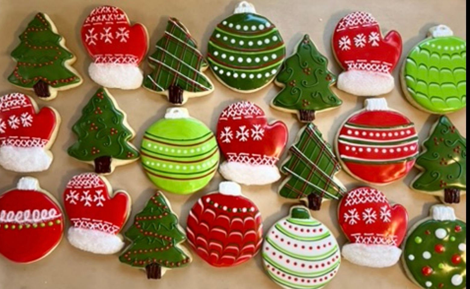 Christmas cookies: trees, mittens, and ornaments decorated with red, green, and white icing. Base Camp Bakery Gunnison, Colorado https://share.google/AgqUzUKNzsb0ThlP5, https://www.facebook.com/BaseCampBakery1, https://www.instagram.com/basecampbakery_81230