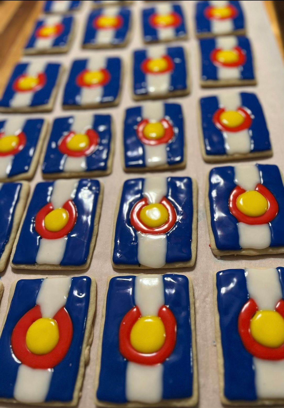 Cookies decorated with the Colorado flag: blue, white, and red stripes with a yellow center. Base Camp Bakery Gunnison, Colorado https://share.google/AgqUzUKNzsb0ThlP5, https://www.facebook.com/BaseCampBakery1, https://www.instagram.com/basecampbakery_81230