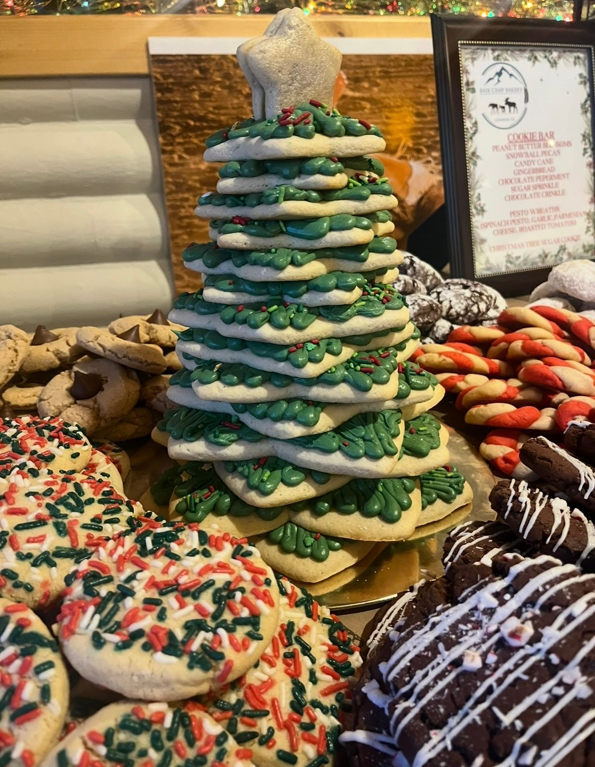 Cookies in cellophane packaging: chocolate crinkles, white-dipped with holly, and crumble-topped. Base Camp Bakery Gunnison, Colorado https://share.google/AgqUzUKNzsb0ThlP5, https://www.facebook.com/BaseCampBakery1, https://www.instagram.com/basecampbakery_81230