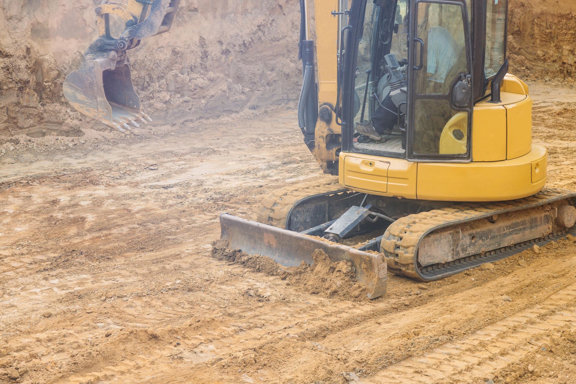 A Yellow Excavator is Moving Dirt on a Construction Site