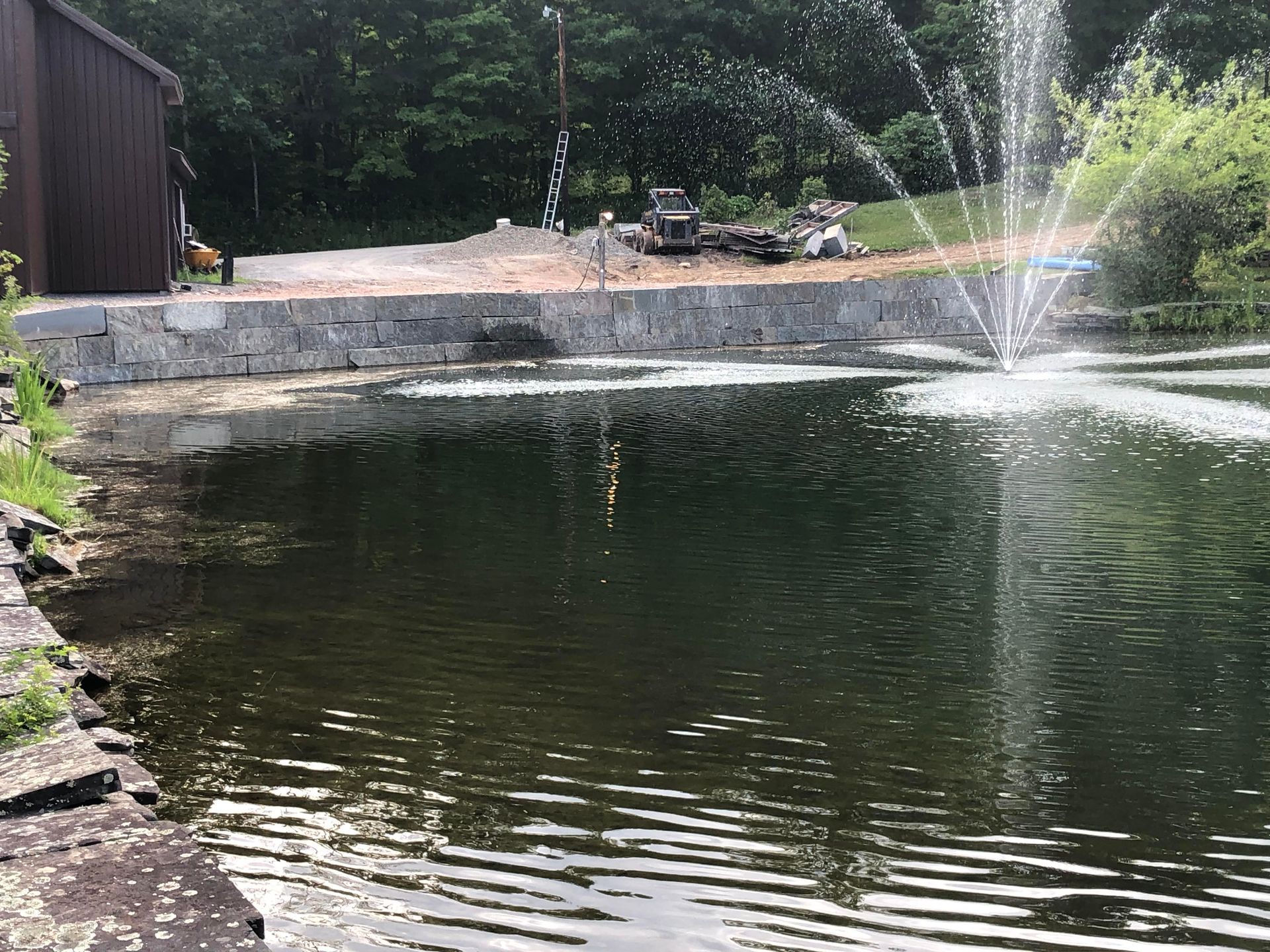 A Pond With a Fountain in the Middle of It