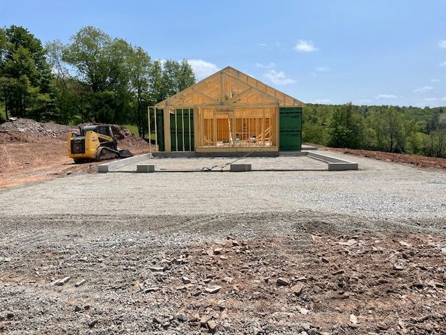 A House is Being Built in the Middle of a Dirt Field