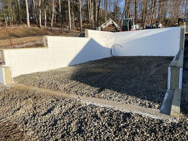 A Pile of Gravel is Sitting in Front of a White Wall