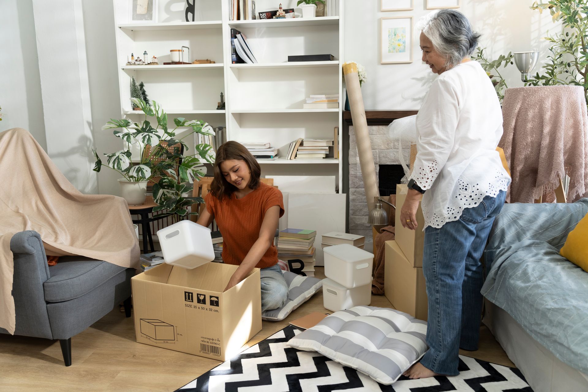 A woman and an older woman are moving into a new home.