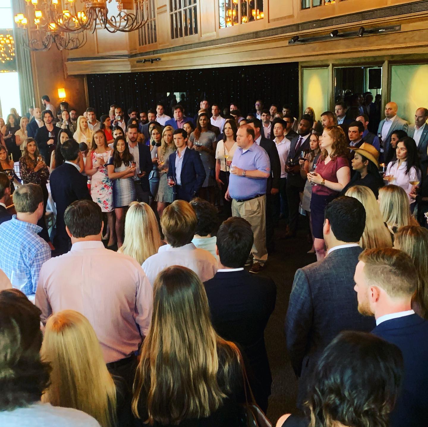 A large group of people are gathered in a room