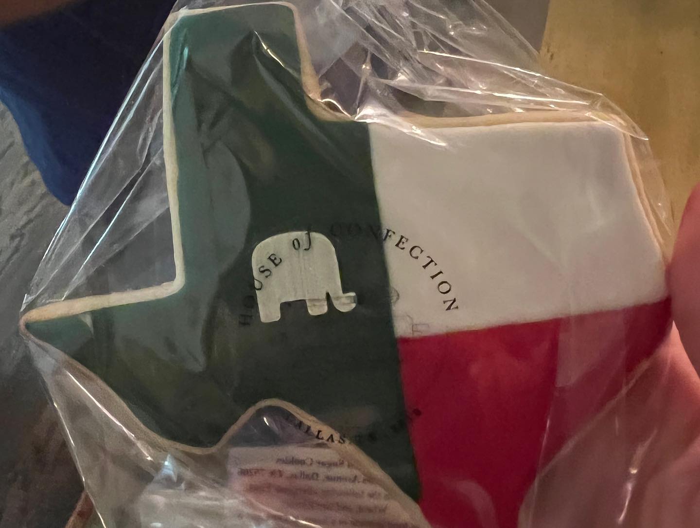 A person is holding a texas cookie in a plastic bag