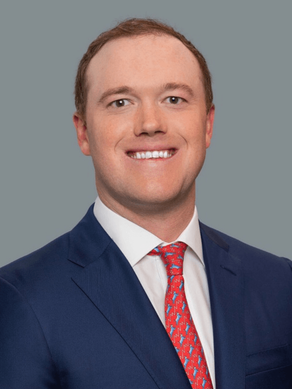 A man in a suit and tie is smiling for the camera.