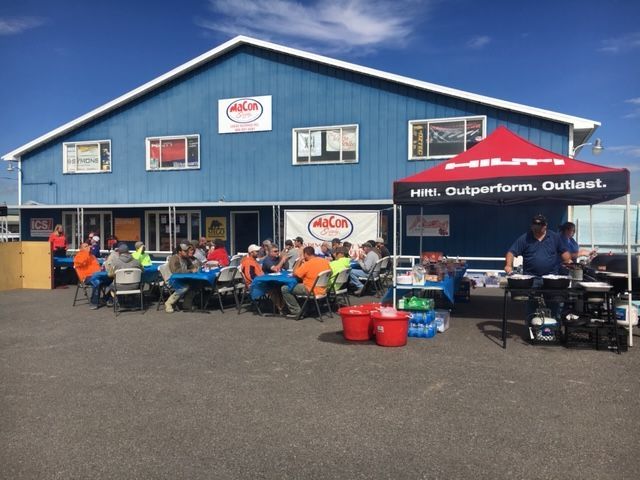 Outdoor customer appreciation event at Macon facility featuring Hilti Tools tent, food service, and construction professionals.