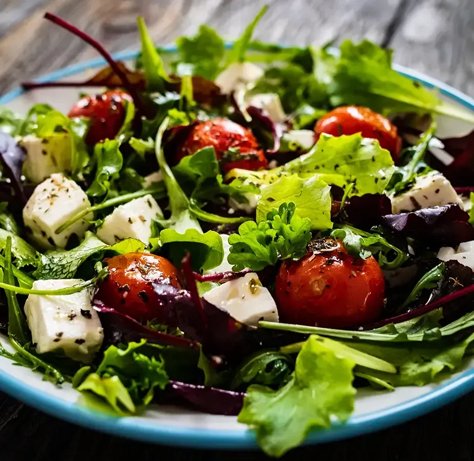 Mediterranean salad with Arugula, cherry tomatoes, kalamata olives, red onion - finished with crumbled feta and lemon-herb vinaigrette.