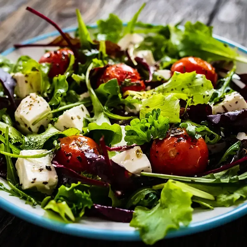 Garden fresh Mediterranean salad with arugula and romaine lettuce, chickpeas, cucumber, cherry tomato, kalamata olives and red onion - finished with crumbled feta and lemon-herb vinaigrette.