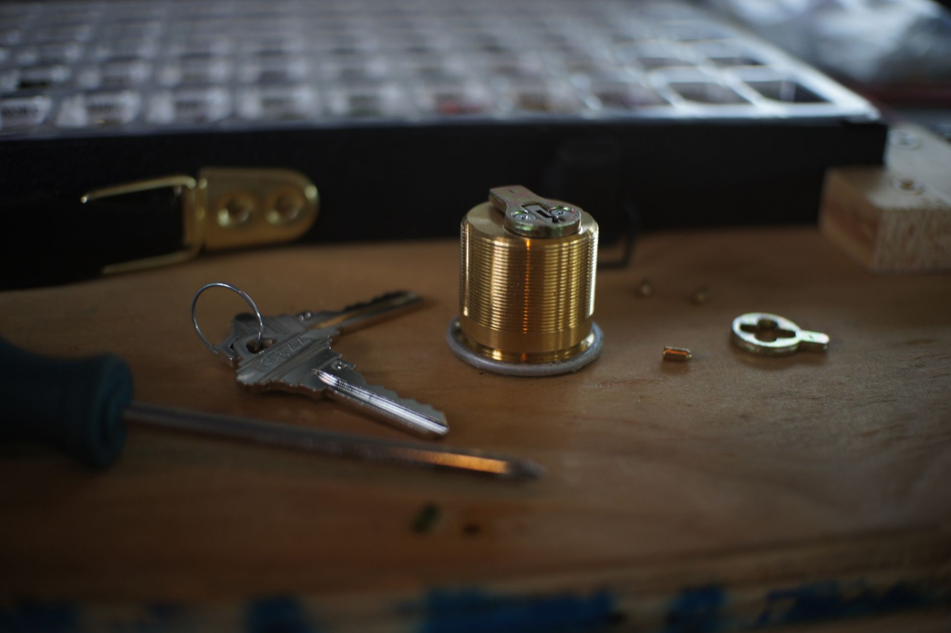 A person is fixing a door lock with a screwdriver.
