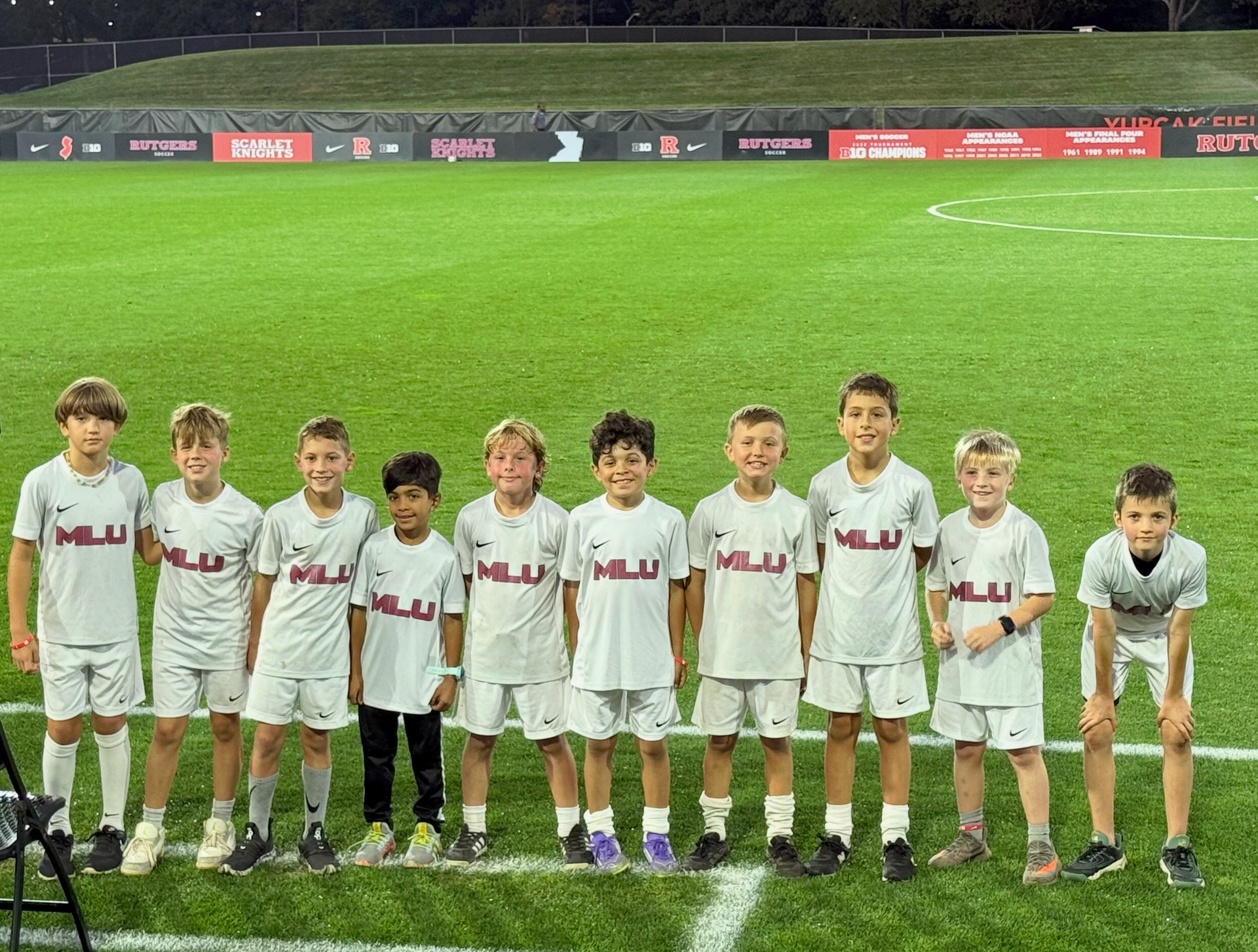 Mount Laurel United Soccer team smiling on a field