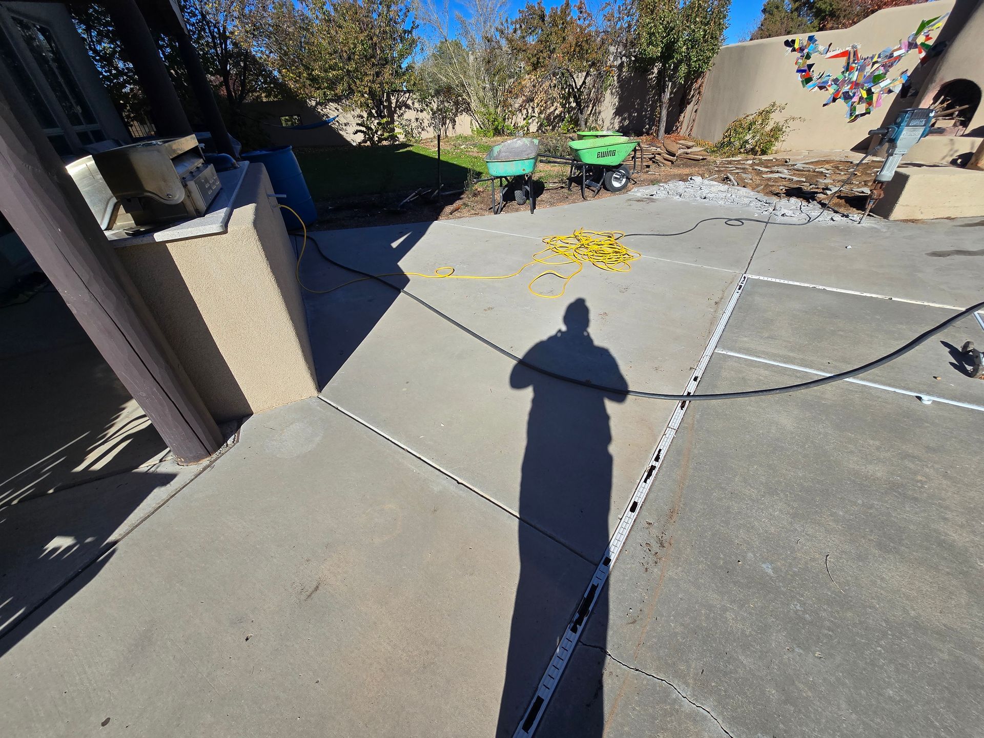 A shadow of a person is cast on a concrete surface.