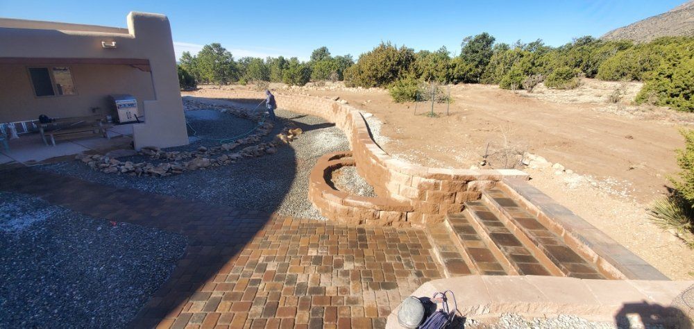 A brick walkway leading to a house in the desert.
