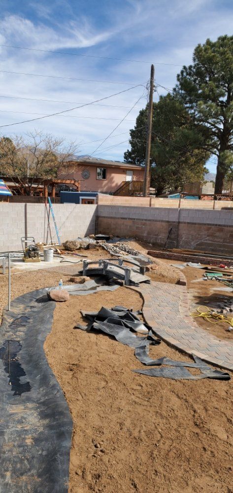 A large pile of dirt is sitting in front of a house.