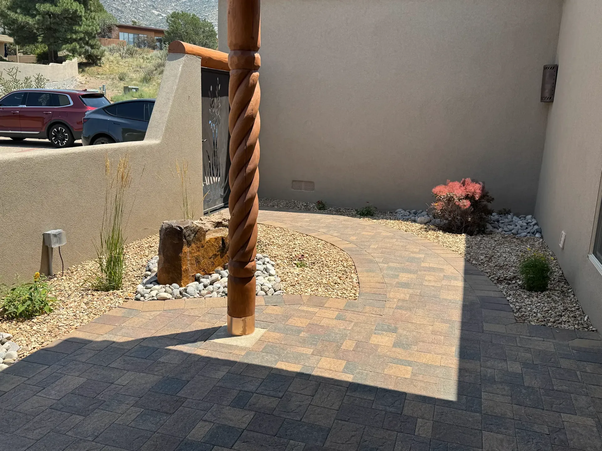 A patio with a wooden pole in the middle of it