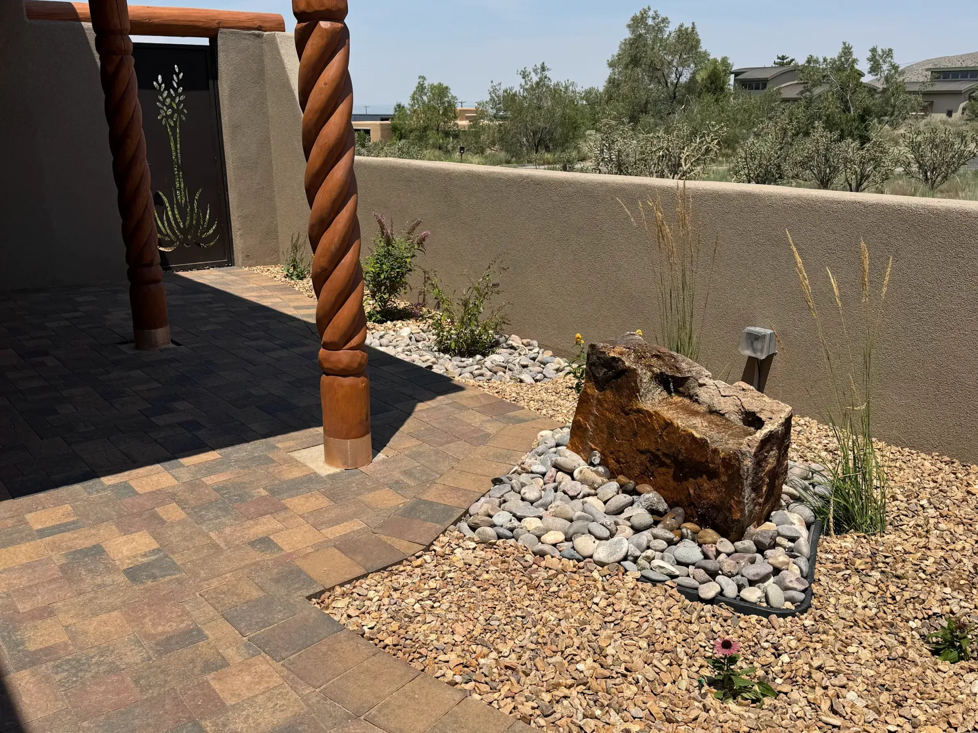 A brick walkway with a rock in the middle of it