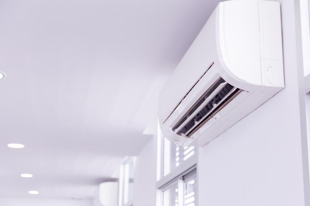 A White Air Conditioner Is Hanging on A White Wall in A Hallway — Northernair in Casino, NSW