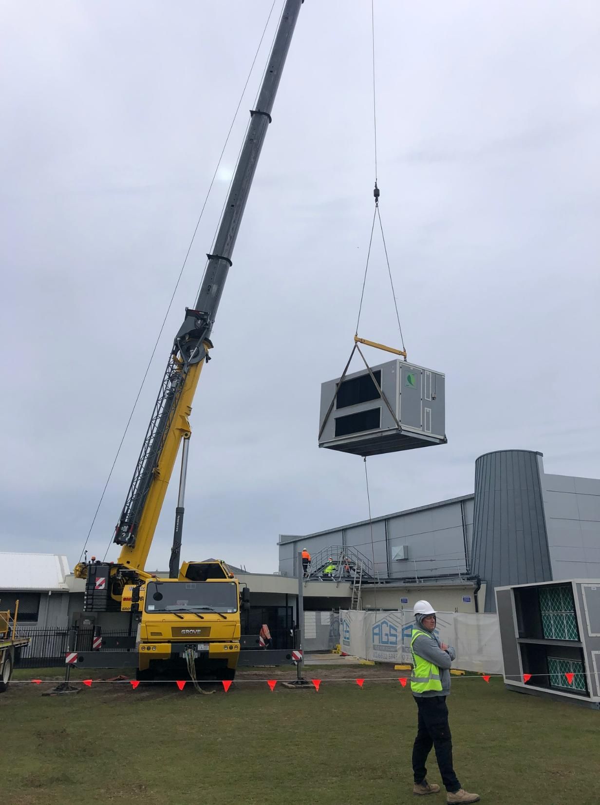 A Large Yellow Crane Is Lifting a Large Box Into the Air — Northernair in Lennox Head, NSW