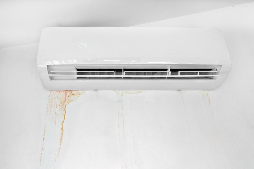 A White Air Conditioner Is Leaking Water on A White Wall — Northernair in Byron Bay, NSW