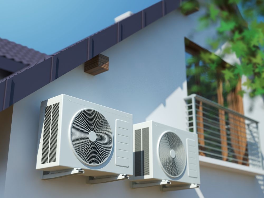 Two Air Conditioners Are Mounted on the Side of a Building — Northernair in Lennox Head, NSW