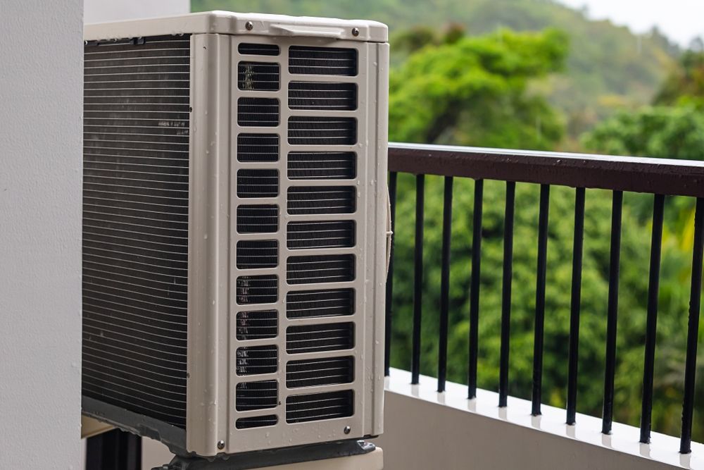 An Air Conditioner is Sitting on a Balcony Next to a Railing — Northernair in Byron Bay, NSW