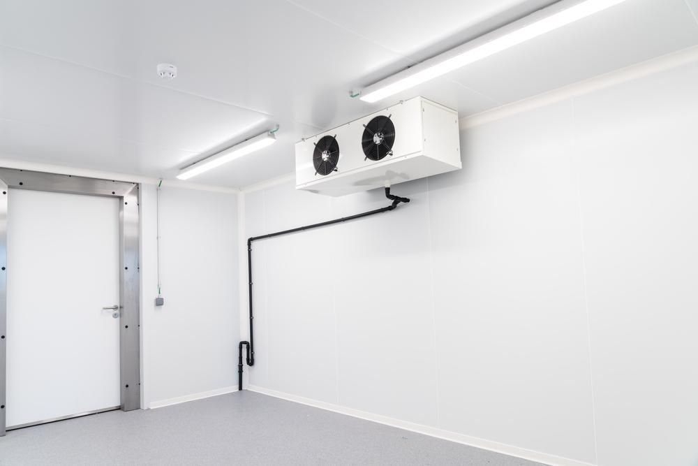 A Room with Two Fans Hanging from The Ceiling and A Door — Northernair in Lennox Head, NSW