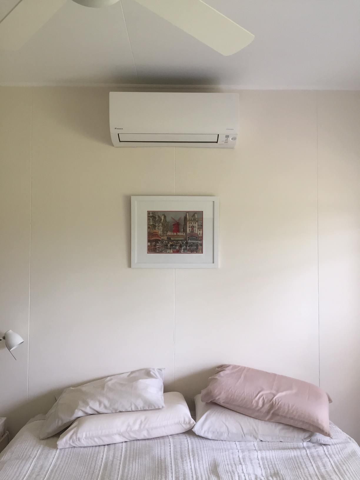 There Is a Picture on The Wall Above the Bed and A Ceiling Fan — Northernair in Alstonville, NSW