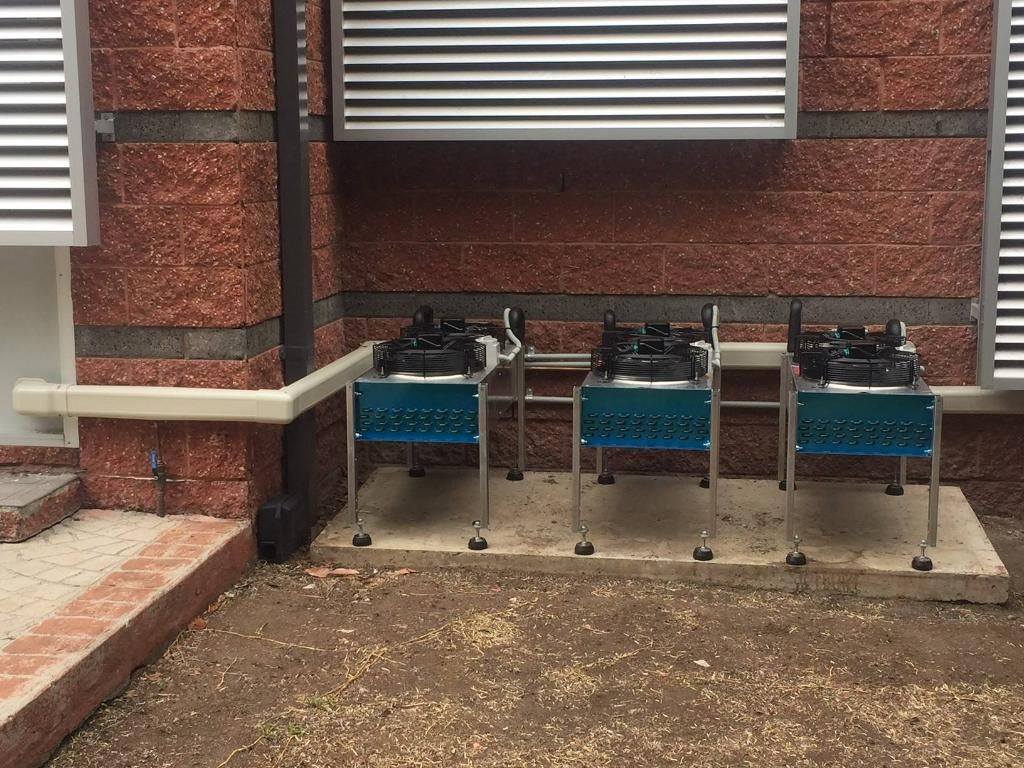 Three Air Condition Condenser Are Sitting Outside of A Brick Building — Northernair in Kyogle, NSW