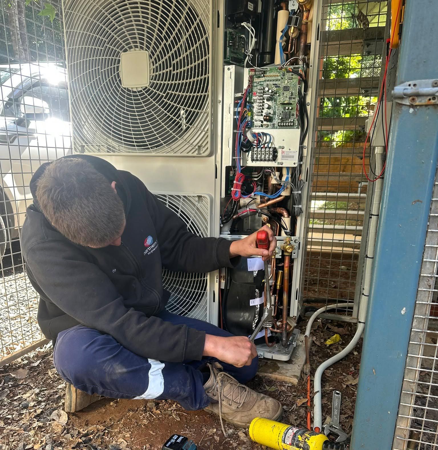 Man Repairing Air Conditioning In Lismore
