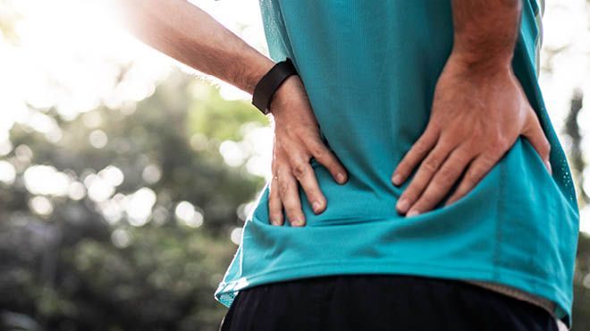Man supporting his lower back with his hands
