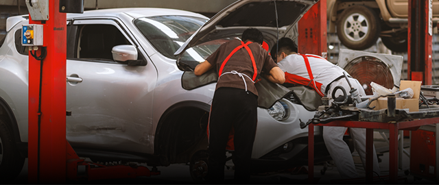Mechanics working on a white car