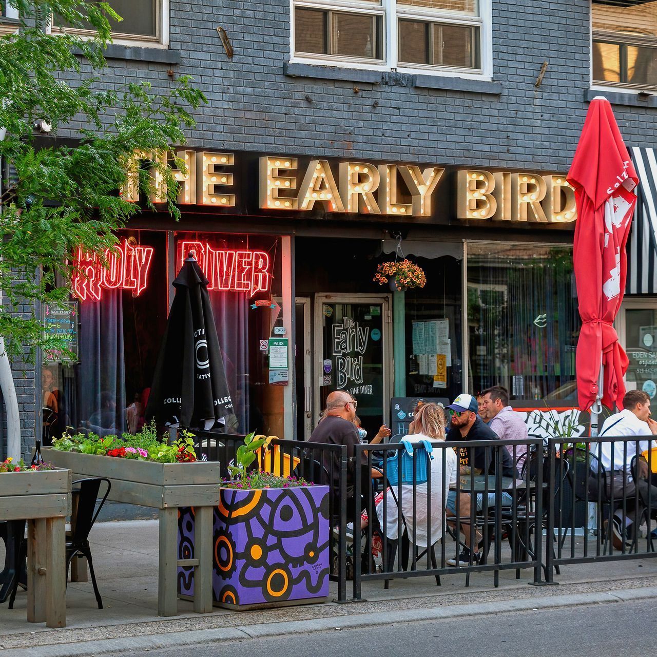 People are sitting outside the early bird restaurant