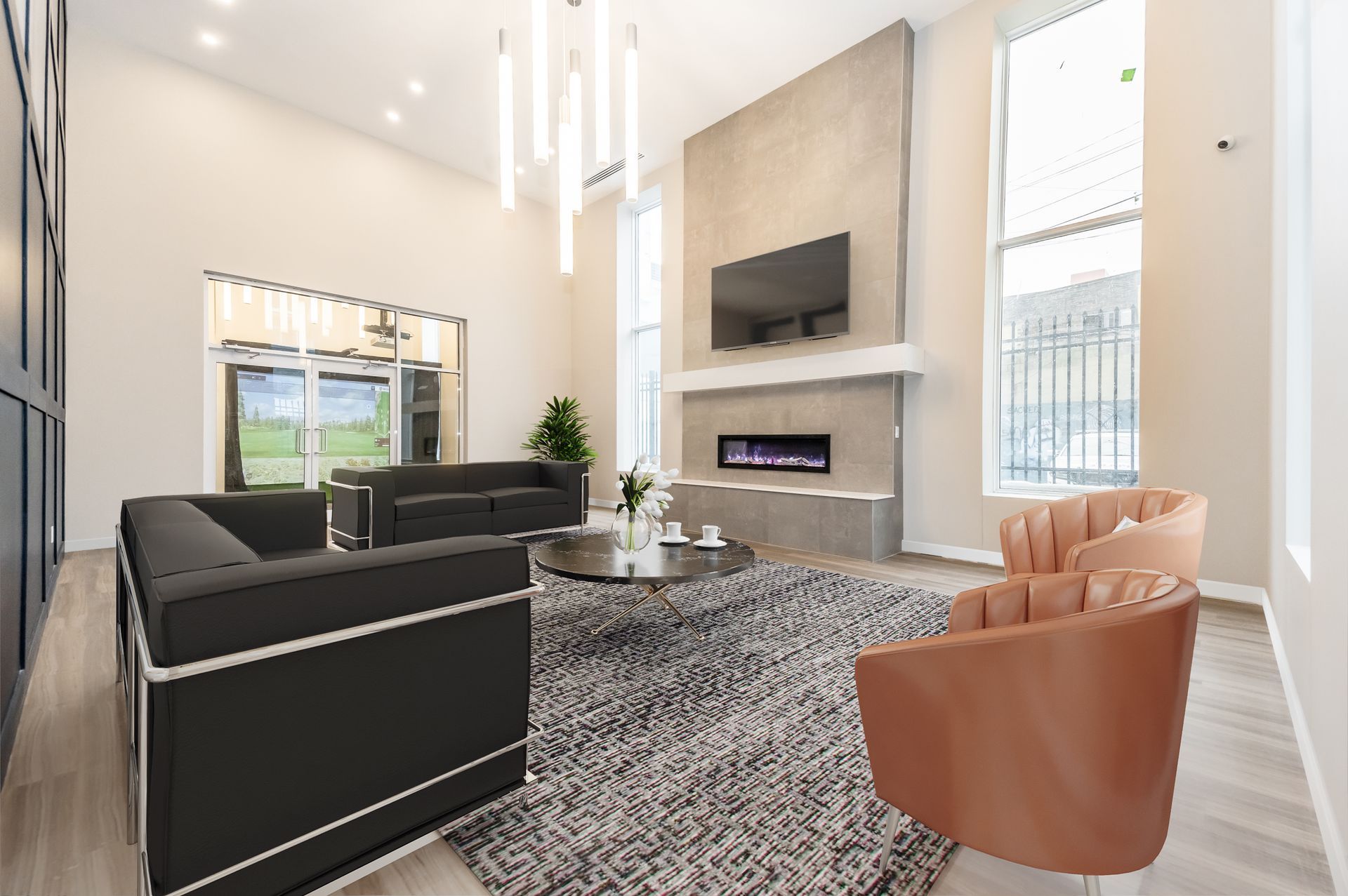 A living room with a couch , chairs , and a fireplace.
