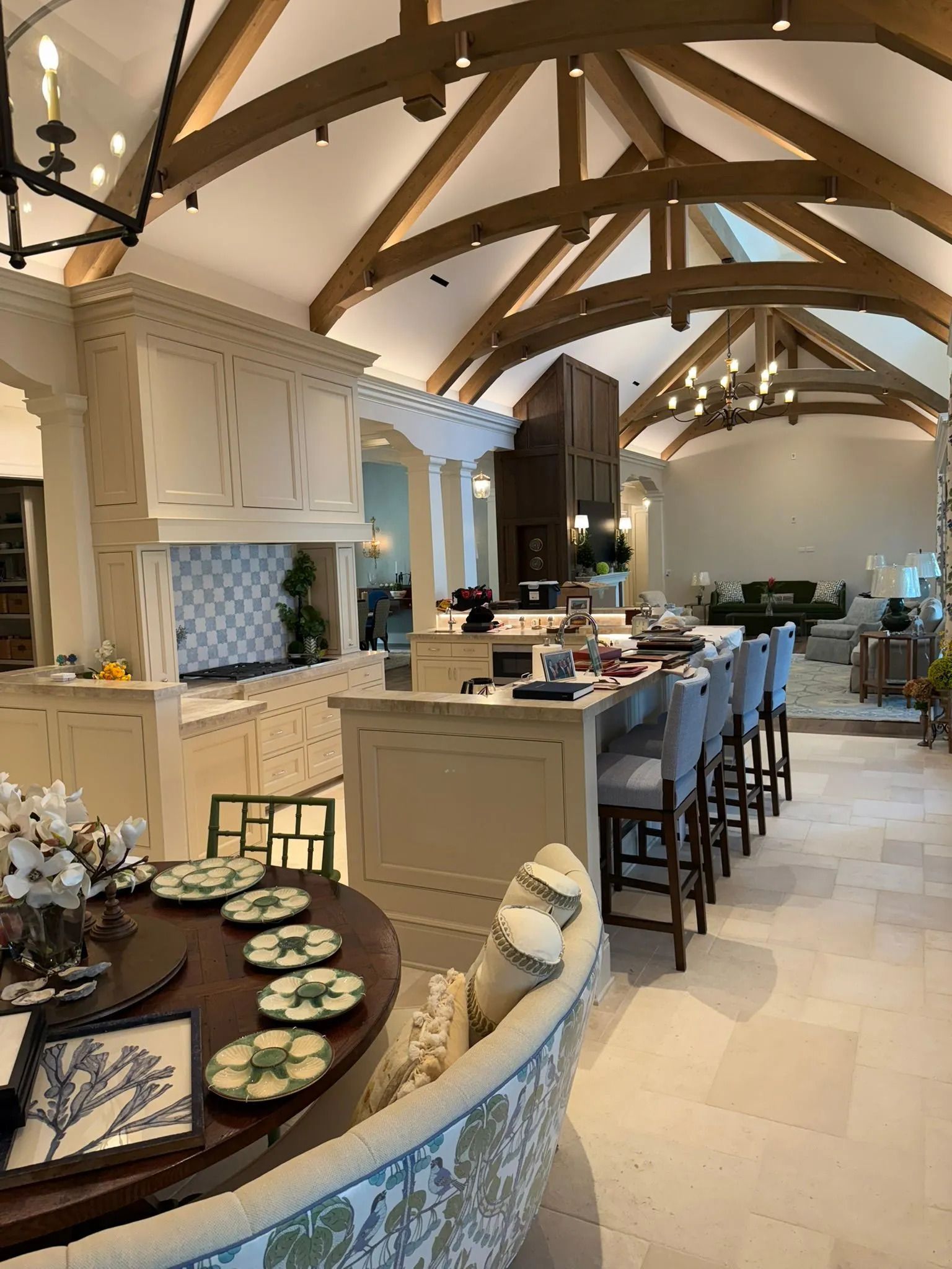 Elegant rustic dining room with vaulted wooden beams, long table, and set place settings.