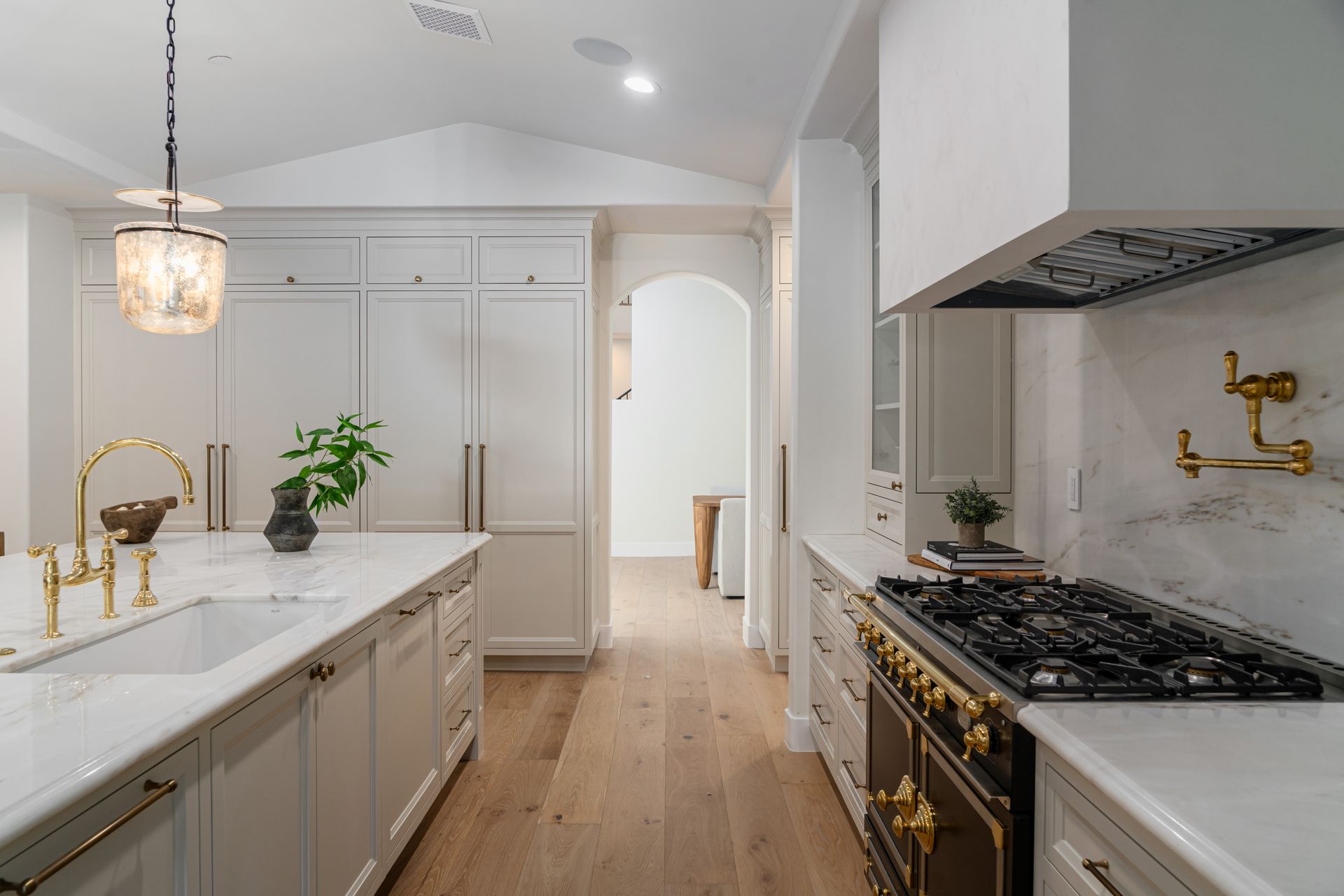 A kitchen with a stove , sink , and refrigerator.