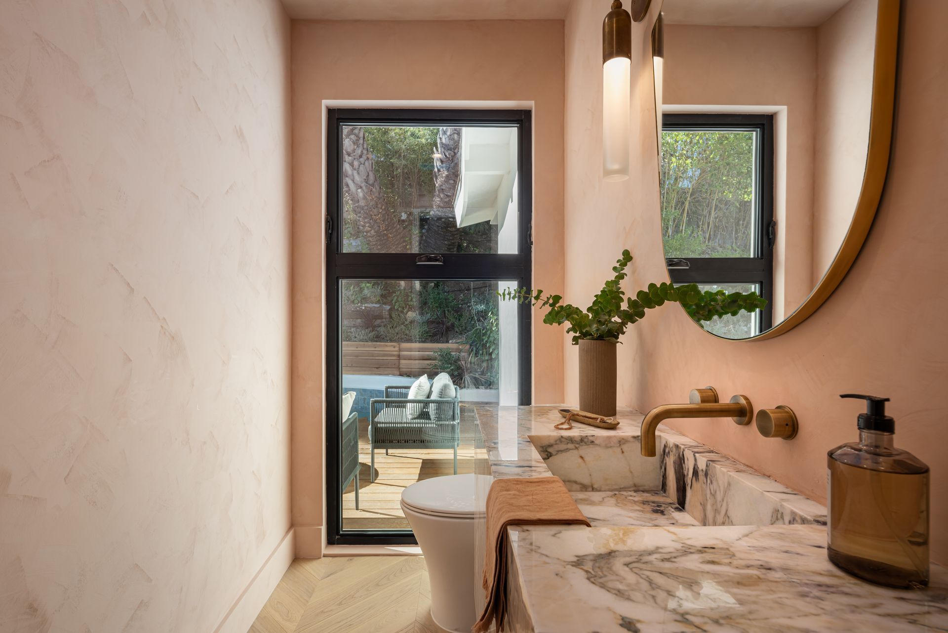A bathroom with a sink , toilet and mirror.