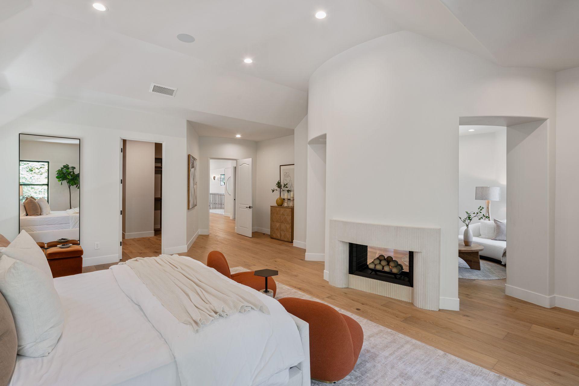There is a fireplace in the middle of the bedroom.
