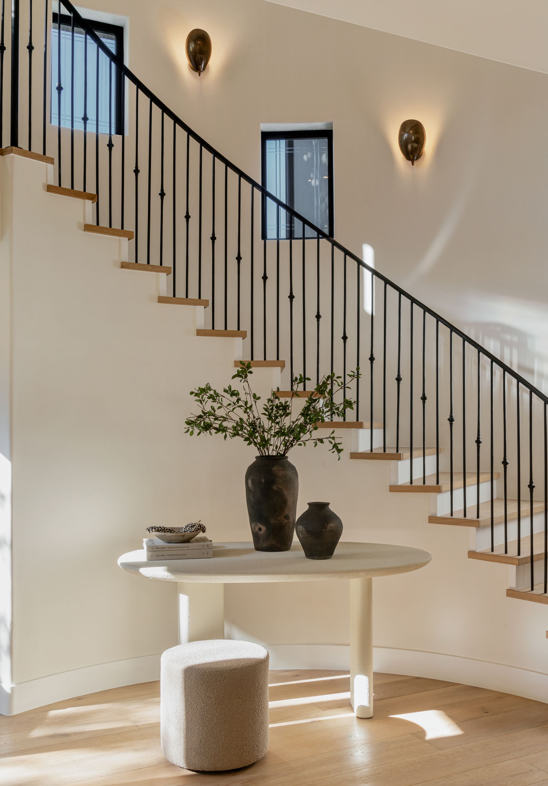 A staircase with a table and vases on it