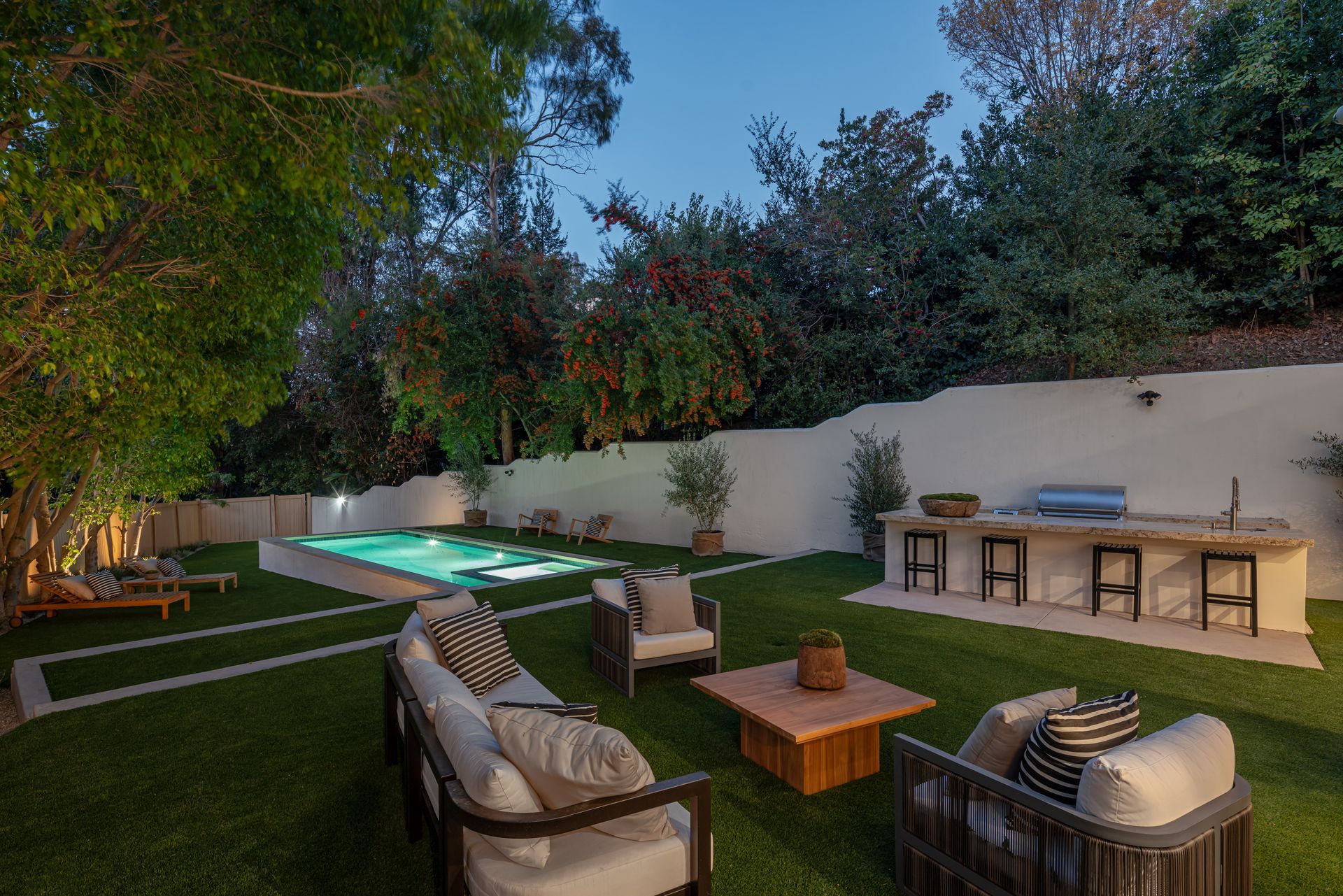 A backyard with a swimming pool and a patio area